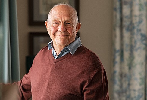 Senior man smiling at home