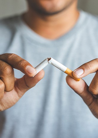 Closeup of patient breaking cigarette