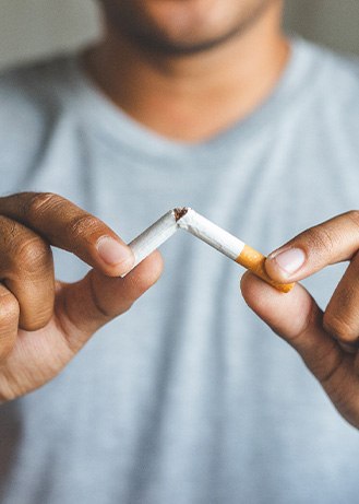 Closeup of patient breaking cigarette