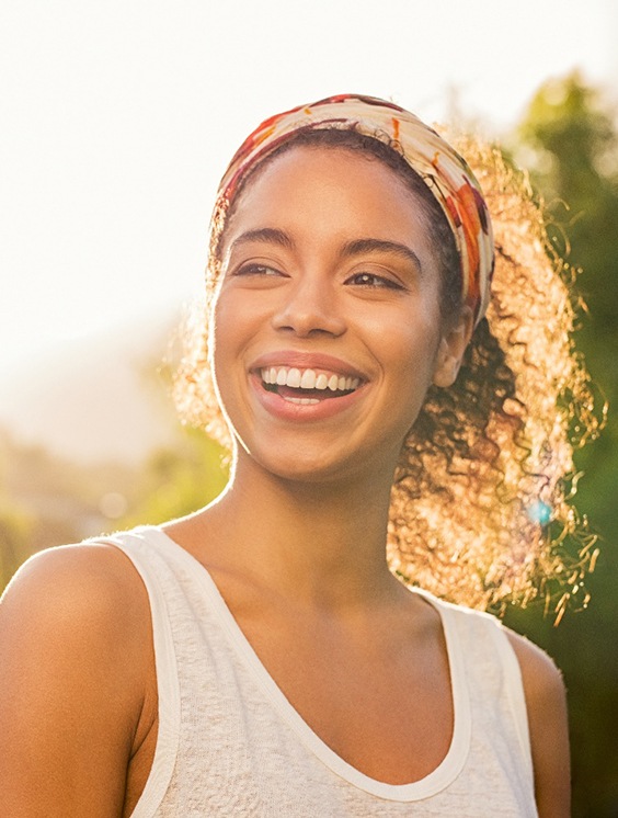 Young female smiling after a visit to her Anthem dentist in Stratford