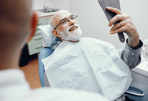 Older man smiling in the dentist’s chair