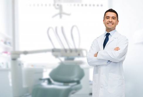 A male dentist smiling