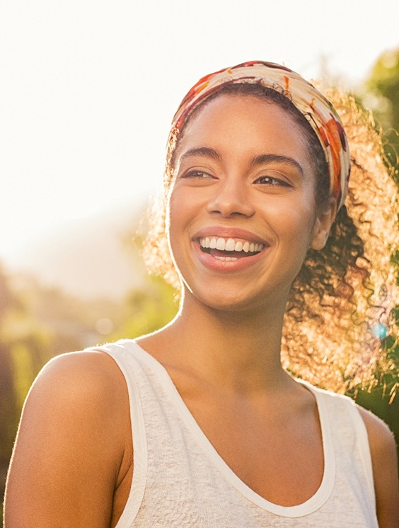 Young female smiling after visiting her Delta Dental dentist in Stratford