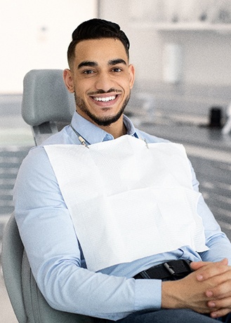 Patient smiling while sitting in treatment chair