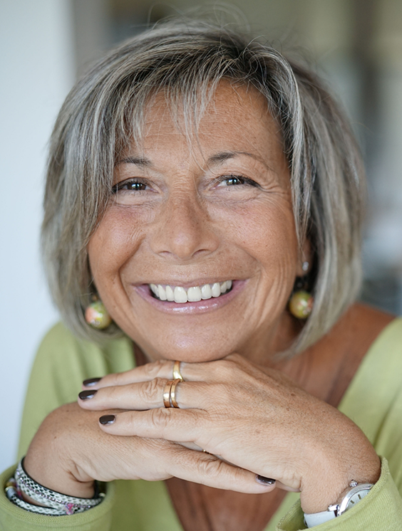 Woman with chin length gray hair smiling
