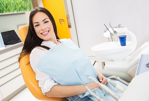 Grinning woman in the dental chair