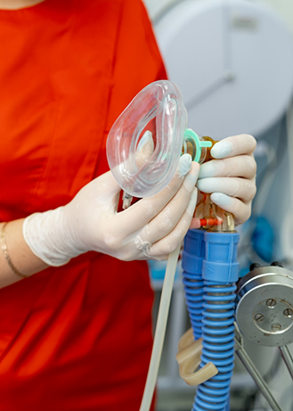 Sedation dentist holding a nasal mask for nitrous oxide