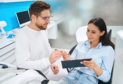 A woman filling out dental insurance paperwork