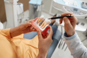 a patient and their dentist talking about dental implants